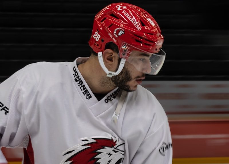 a hockey player with a red helmet and goggles